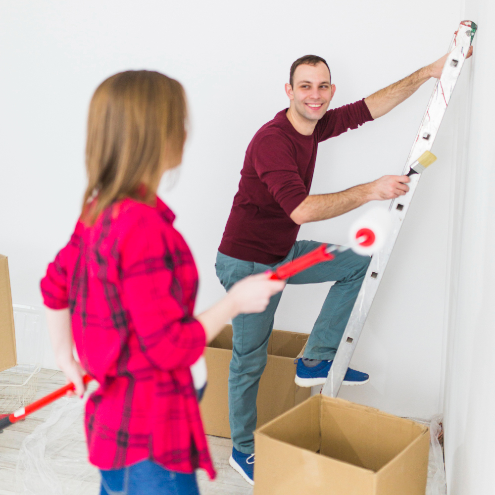 young-couple-painting-walls-smiling
